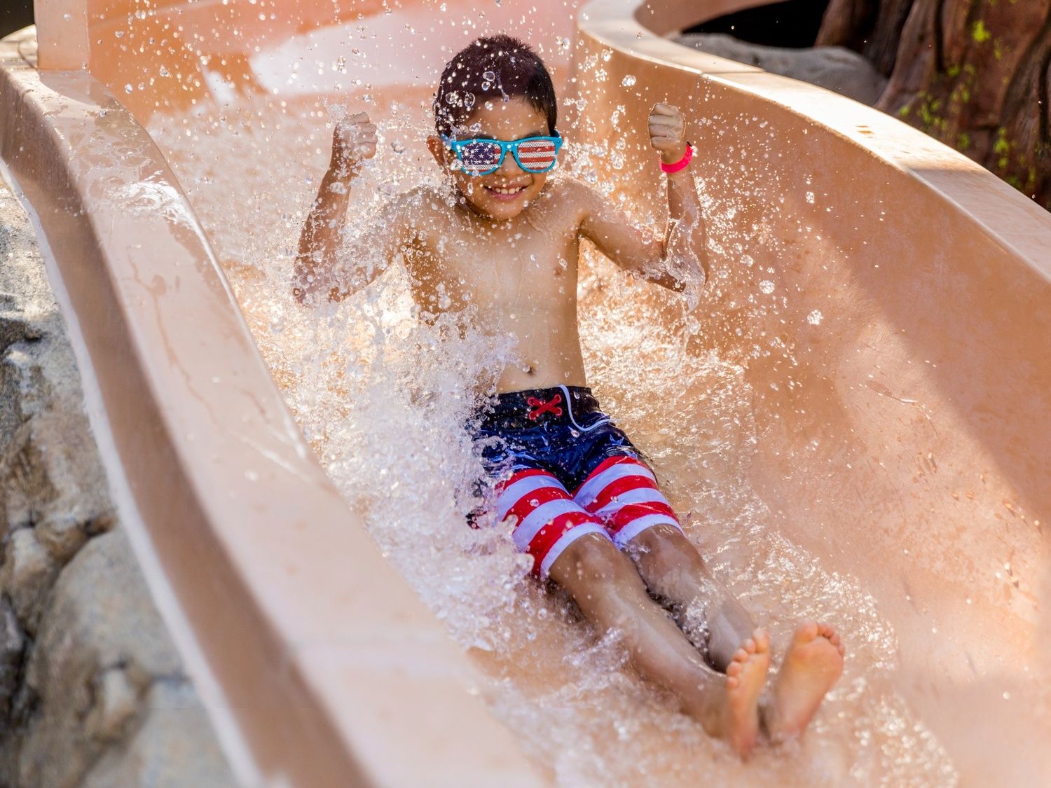 A young boy on a waterslide